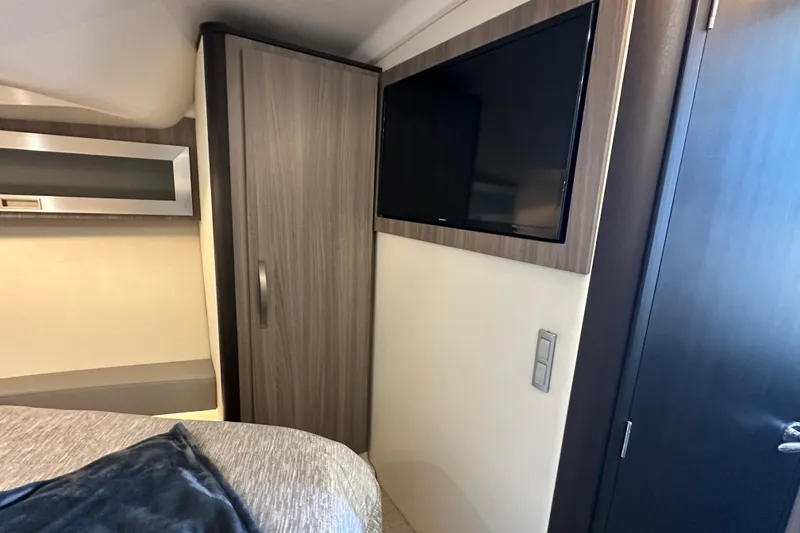 Slide: The Image of 2021 Regal 36 XO cabin interior with TV, wardrobe, and modern design elements. - 22