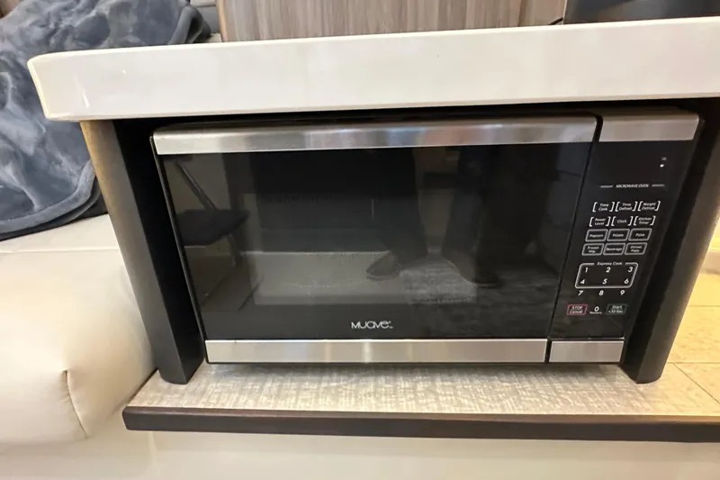 Slide: The Image of Microwave oven inside 2021 Regal 36 XO yacht, featuring modern design and digital controls. - 26