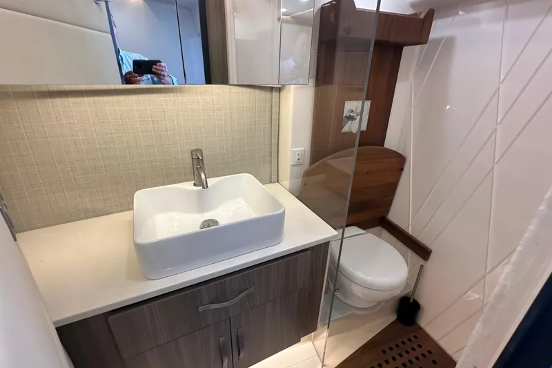Slide: The Image of Modern bathroom in 2021 Regal 36 XO yacht with sleek sink and toilet. - 32