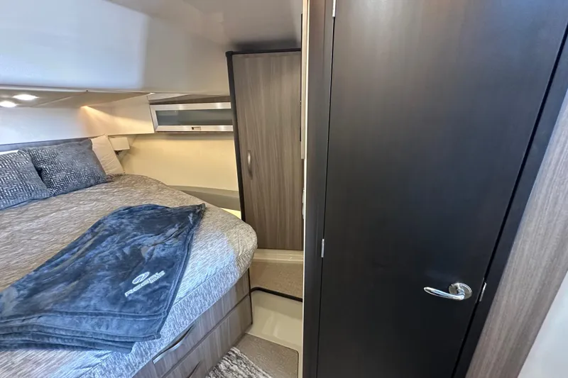 Slide: The Image of 2021 Regal 36 XO yacht interior cabin with bed, closet, and modern design. - 35