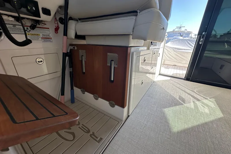 Slide: The Image of 2021 Regal 36 XO yacht interior with seating and storage, showcasing luxury design. - 36