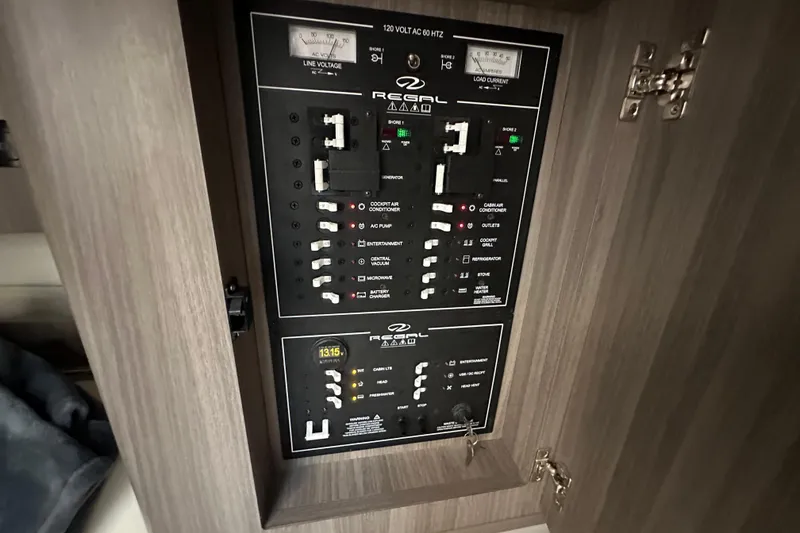 Slide: The Image of Electrical panel of 2021 Regal 36 XO boat, featuring various switches and controls. - 37