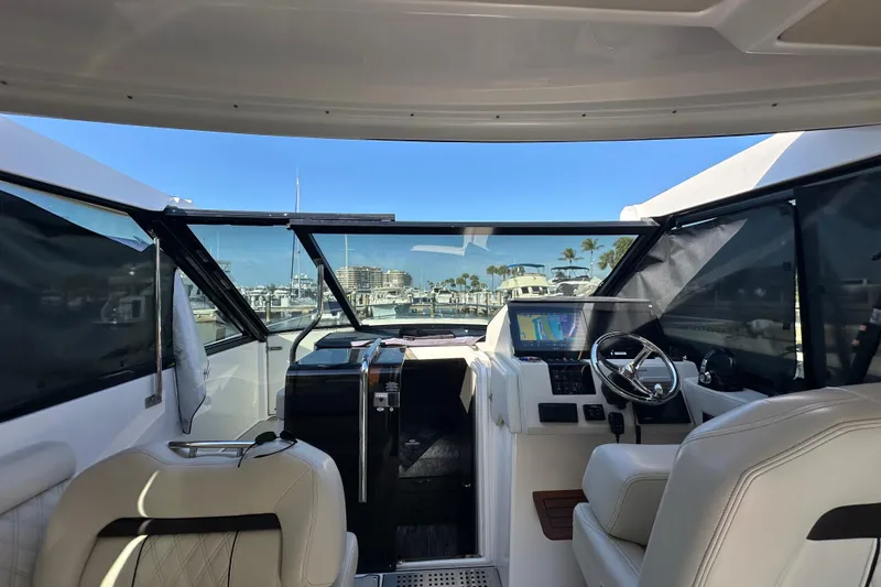 Slide: The Image of Interior view of 2021 Regal 36 XO yacht cockpit with steering wheel and navigation display. - 38