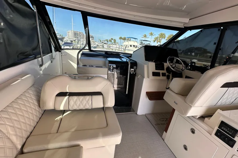Slide: The Image of Interior of a 2021 Regal 36 XO yacht with luxurious seating and helm. - 4