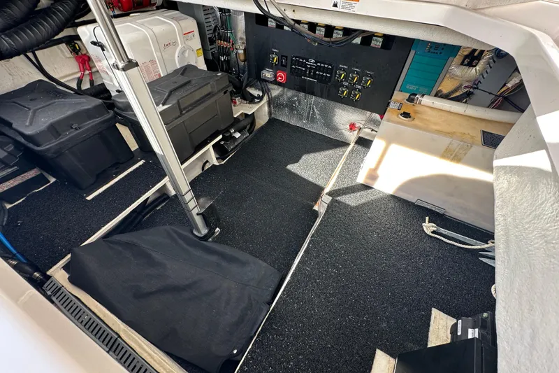 Slide: The Image of Engine room of 2021 Regal 36 XO boat, featuring batteries and control panel. - 44