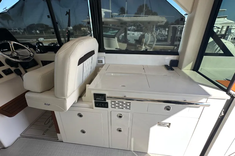 Slide: The Image of 2021 Regal 36 XO yacht interior with helm seat and control panel. - 5