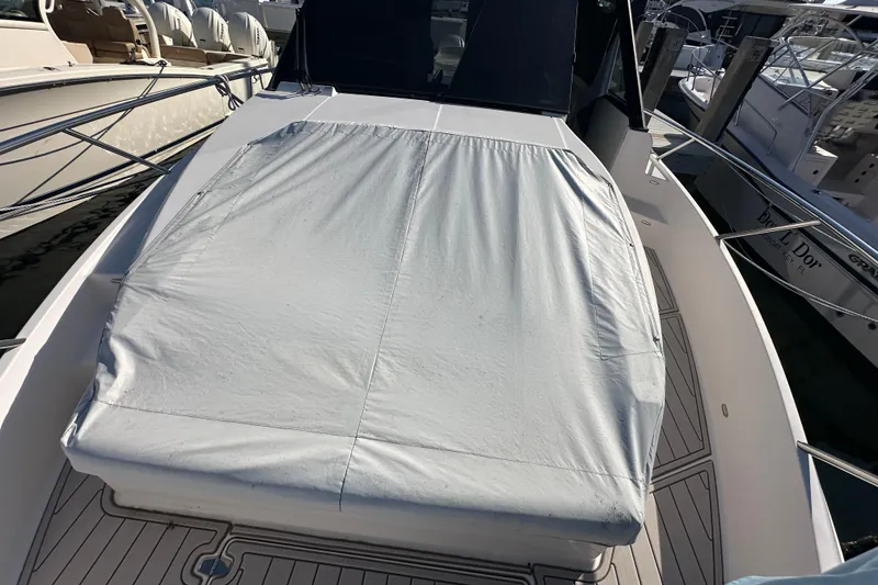 Slide: The Image of 2021 Regal 36 XO boat with covered deck, docked at marina. - 50