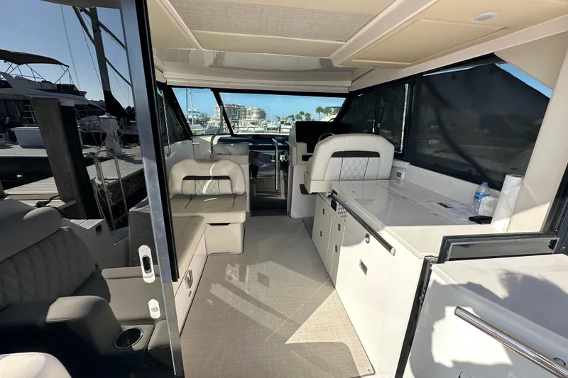 Slide: The Image of Interior of 2021 Regal 36 XO yacht, featuring modern seating and sleek design. - 55