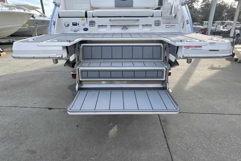 Slide: The Image of 2024 Chaparral 287 SSX boat with extended swim platform and fold-out steps. - 15