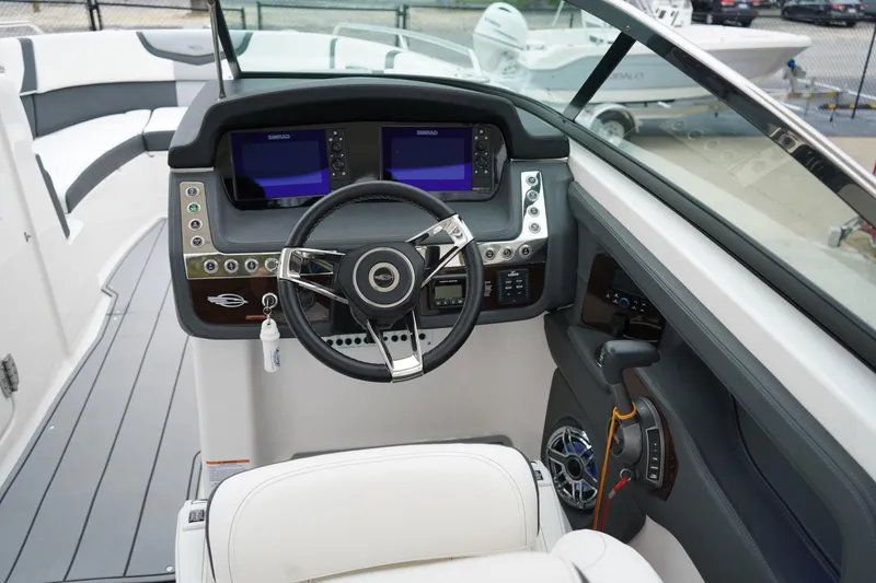 Slide: The Image of 2024 Chaparral 287 SSX boat dashboard with modern controls and steering wheel. - 4