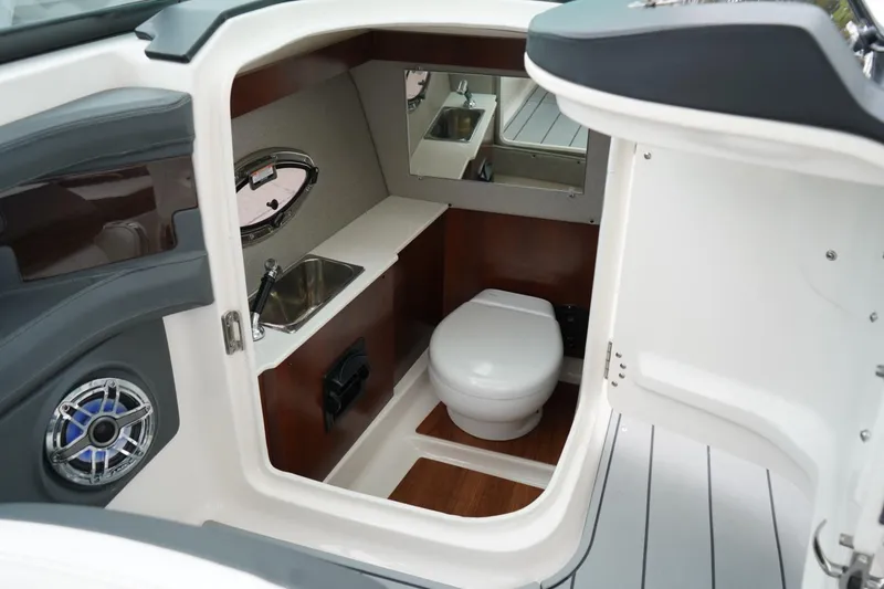 Slide: The Image of 2024 Chaparral 287 SSX boat interior with toilet, sink, and mirror. - 5