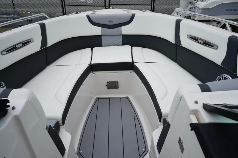 Slide: The Image of 2024 Chaparral 287 SSX boat interior with sleek white and gray seating. - 6