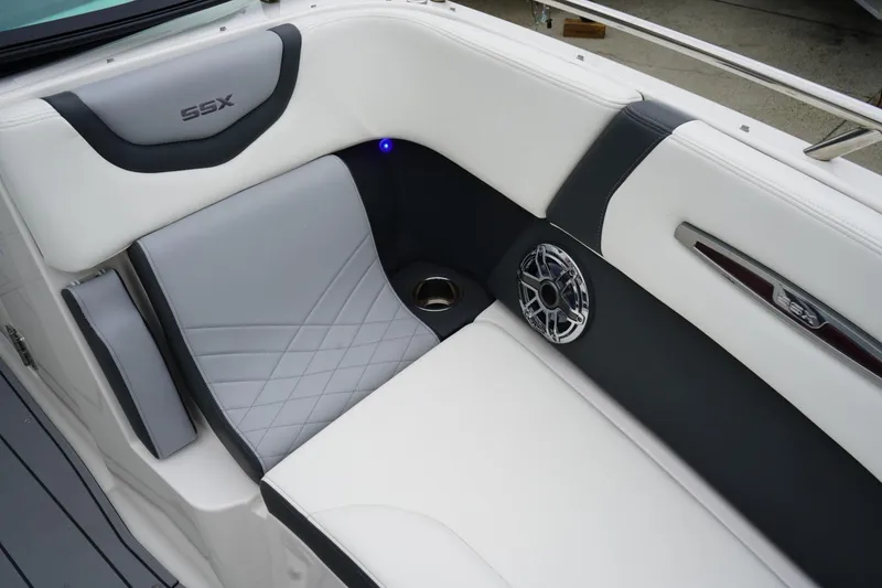 Slide: The Image of 2024 Chaparral 287 SSX boat interior with luxurious seating and speaker detail. - 7