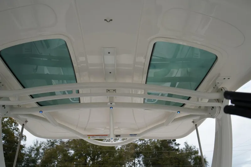 Slide: The Image of 2024 Chaparral 287 SSX boat roof with glass panels and structural supports. - 9