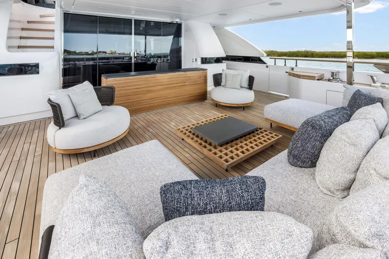 Slide: The Image of Luxurious 2023 Custom Line NAVETTA 42 yacht deck with elegant seating and ocean view. - 13
