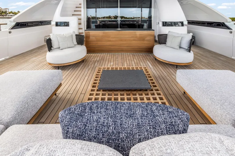Slide: The Image of Luxurious 2023 Custom Line NAVETTA 42 yacht deck with modern seating and elegant design. - 14