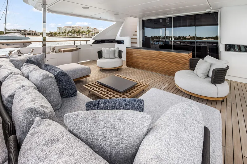 Slide: The Image of Luxurious 2023 Custom Line NAVETTA 42 yacht deck with modern seating and elegant design. - 15