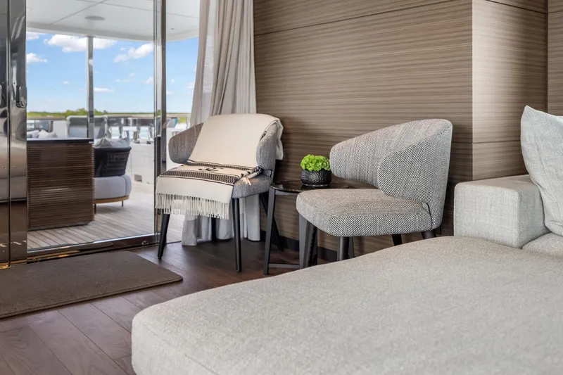 Slide: The Image of Luxurious interior of 2023 Custom Line NAVETTA 42 yacht with elegant seating and panoramic windows. - 17