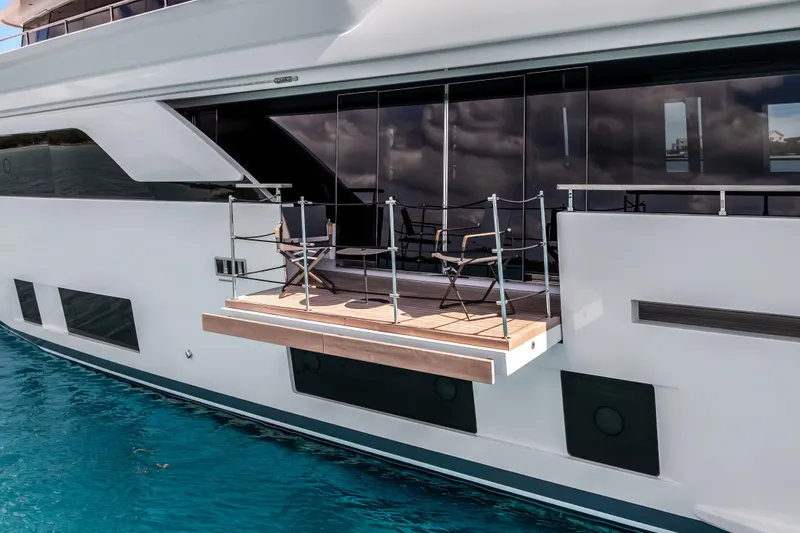 Slide: The Image of Luxurious 2023 Custom Line NAVETTA 42 yacht cruising on turquoise waters under a clear sky. - 4