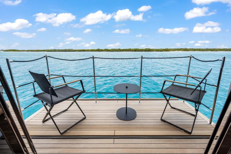 Slide: The Image of Custom Line NAVETTA 42 yacht deck, 2023 model, with ocean view and clear blue sky. - 46