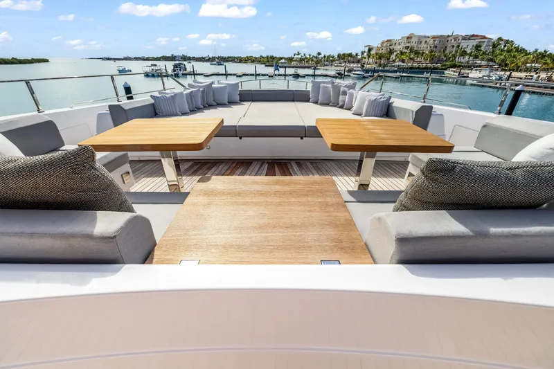 Slide: The Image of Deck view from 2023 Custom Line NAVETTA 42 yacht, featuring chairs and table overlooking the ocean. - 47