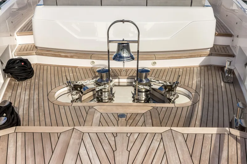 Slide: The Image of Luxurious 2023 Custom Line NAVETTA 42 yacht docked, featuring elegant teak decking and spacious seating area. - 49