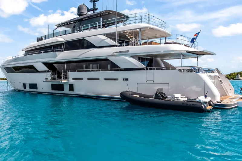 Slide: The Image of Luxurious 2023 Custom Line NAVETTA 42 yacht on clear blue water, featuring sleek design and modern amenities. - 5