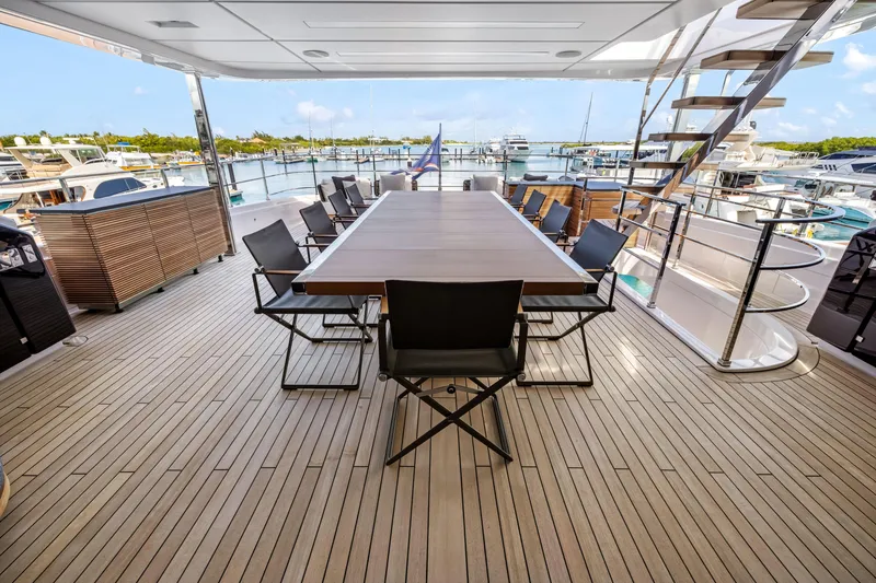 Slide: The Image of Luxurious 2023 Custom Line NAVETTA 42 yacht deck with elegant seating and dining area. - 52