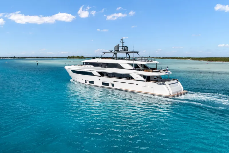 Slide: The Image of Luxury yacht Custom Line NAVETTA 42, 2023 model, featuring a sleek balcony over turquoise water. - 6