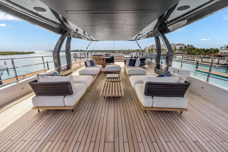 Slide: The Image of Luxurious deck of 2023 Custom Line NAVETTA 42 yacht with plush seating and marina view. - 60