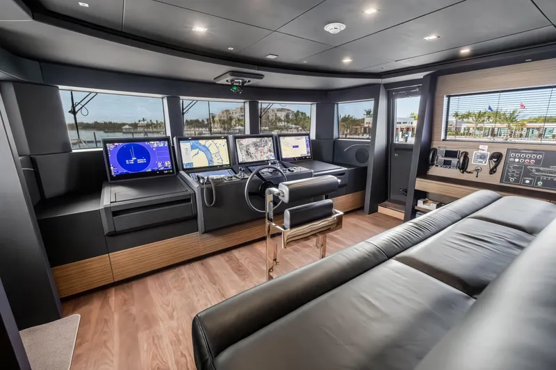 Slide: The Image of Luxurious 2023 Custom Line NAVETTA 42 yacht cabin with modern wood paneling and cozy bedding. - 64