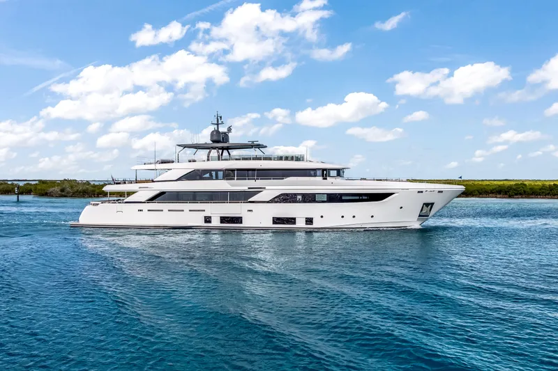 Slide: The Image of Luxurious 2023 Custom Line NAVETTA 42 yacht cruising in clear blue waters. - 7