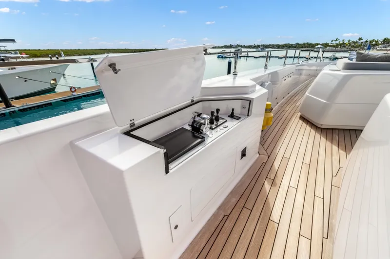 Slide: The Image of Luxurious 2023 Custom Line NAVETTA 42 yacht deck with sleek control panel and scenic marina view. - 70