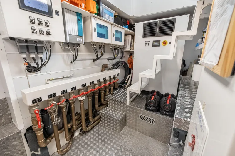 Slide: The Image of Engine room of 2023 Custom Line NAVETTA 42 yacht, showcasing complex machinery and piping. - 74