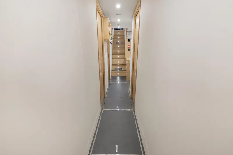 Slide: The Image of Laundry room on 2023 Custom Line NAVETTA 42 yacht with modern appliances and wooden cabinetry. - 82