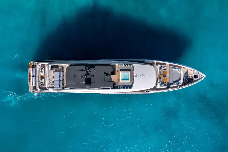 Slide: The Image of Luxurious 2023 Custom Line NAVETTA 42 yacht cruising on clear blue waters. - 9