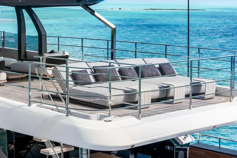 Slide: The Image of Luxurious 2023 Custom Line NAVETTA 42 yacht deck with plush seating, overlooking turquoise ocean waters. - 96