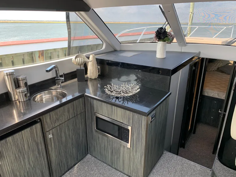 Slide: The Image of Interior of Silverton 4100 SC yacht, modern kitchen with sea view. - 11