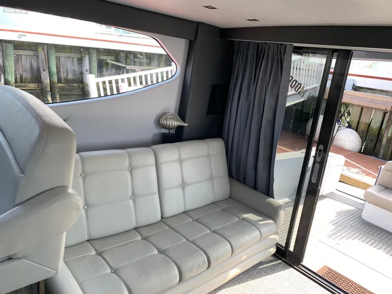 Slide: The Image of Interior of 2019 Silverton 4100 SC yacht with leather sofa and sliding door. - 25