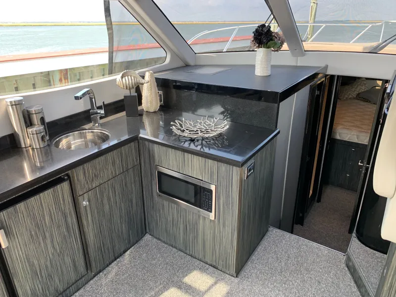 Slide: The Image of Interior of Silverton 4100 SC yacht, modern kitchen with microwave. - 27