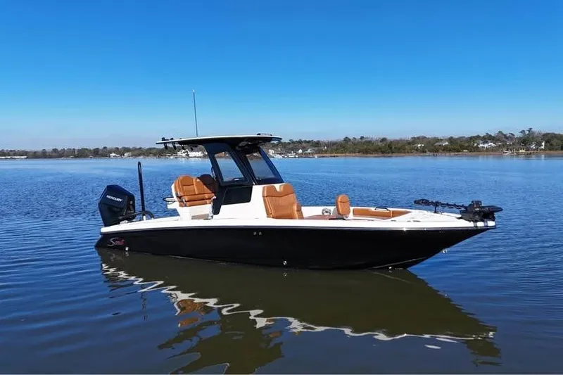 Slide: The Image of 2025 Scout 261 XSS boat on calm water, featuring sleek design and modern amenities. - 1
