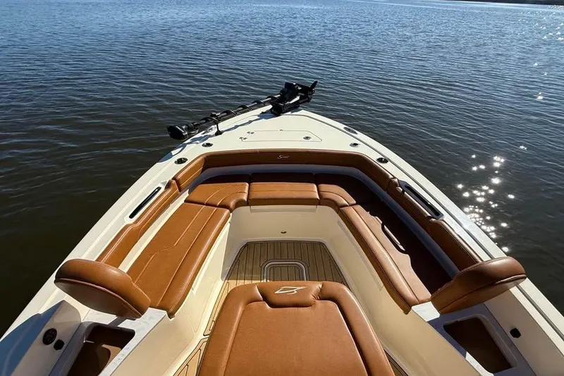 Slide: The Image of 2025 Scout 261 XSS boat with luxurious seating on calm water. - 15