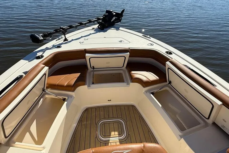 Slide: The Image of 2025 Scout 261 XSS boat interior with cushioned seating and storage compartments. - 16