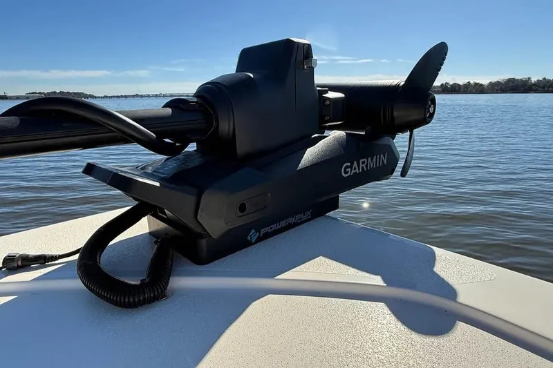 Slide: The Image of Garmin marine equipment on 2025 Scout 261 XSS boat, positioned on calm water. - 19