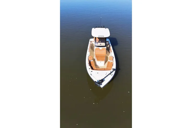Slide: The Image of 2025 Scout 261 XSS boat on calm water, aerial view. - 4