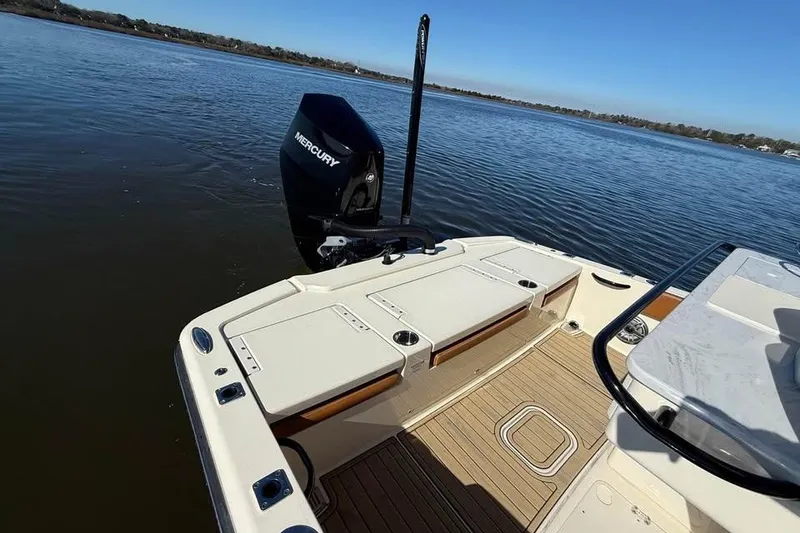 Slide: The Image of 2025 Scout 261 XSS boat with Mercury engine on calm water. - 5