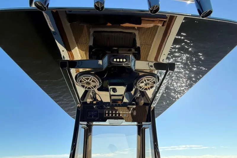 Slide: The Image of 2025 Scout 261 XSS boat console with speakers and controls under a sunny sky. - 9