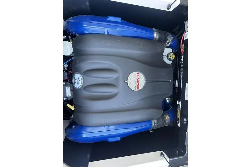 Slide: The Image of 2018 MasterCraft XT22 Ilmor engine with blue accents in boat compartment. - 10