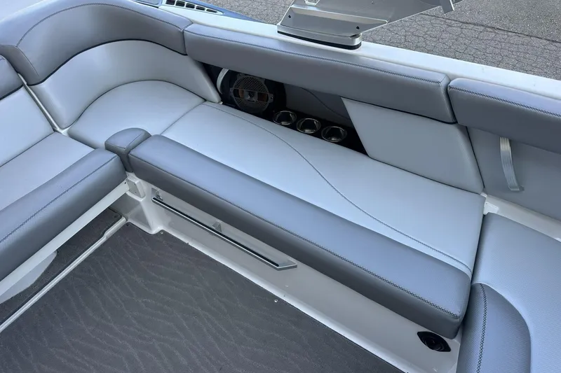 Slide: The Image of 2018 MasterCraft XT22 boat interior with gray seating and cup holders. - 11