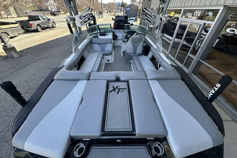 Slide: The Image of 2018 MasterCraft XT22 boat interior with spacious seating and sleek design. - 12